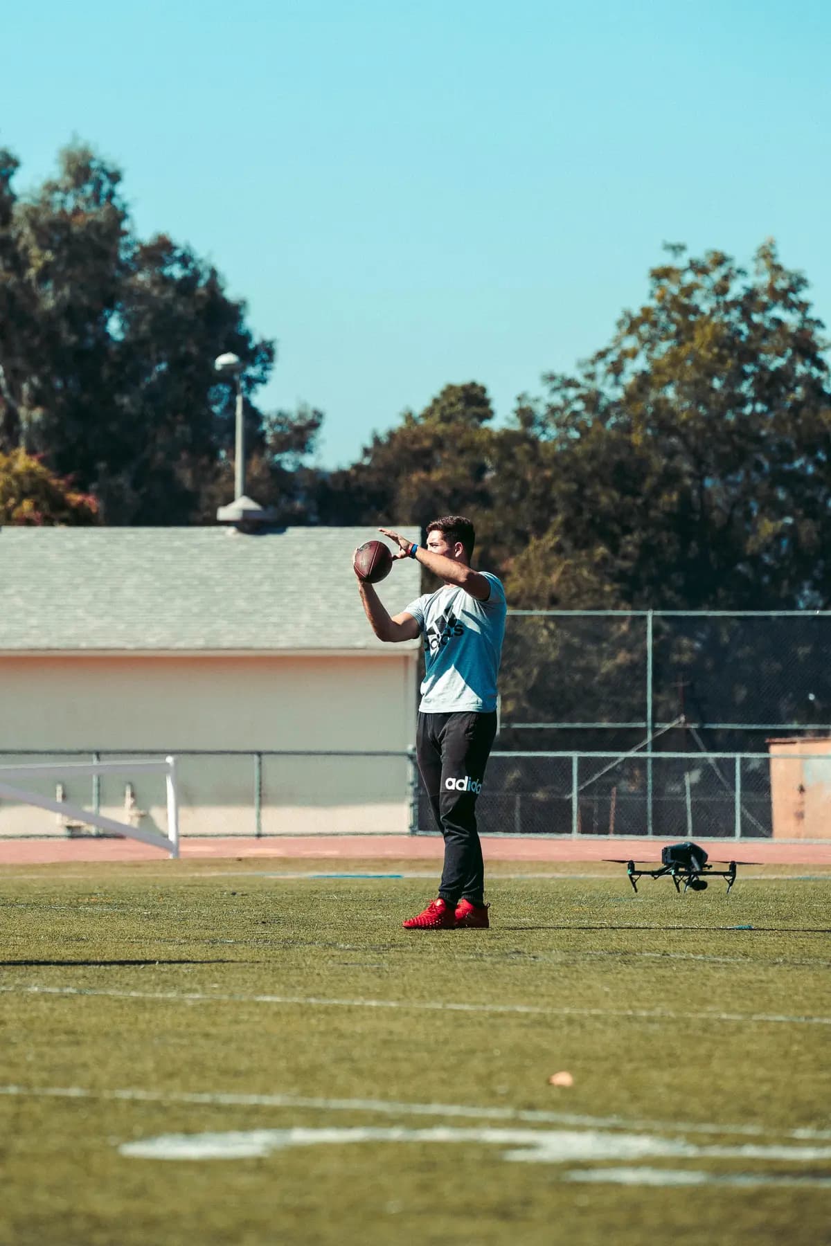 Athlete throwing in daylight as the drone tracks him