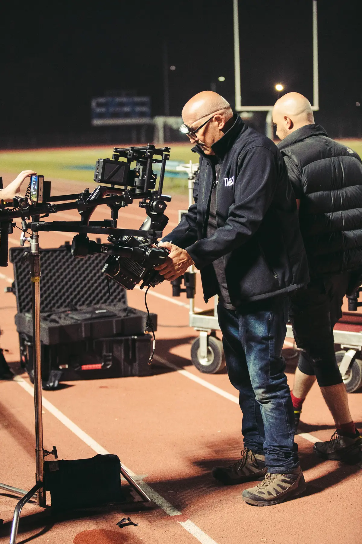 Crew building the camera rig on the sideline