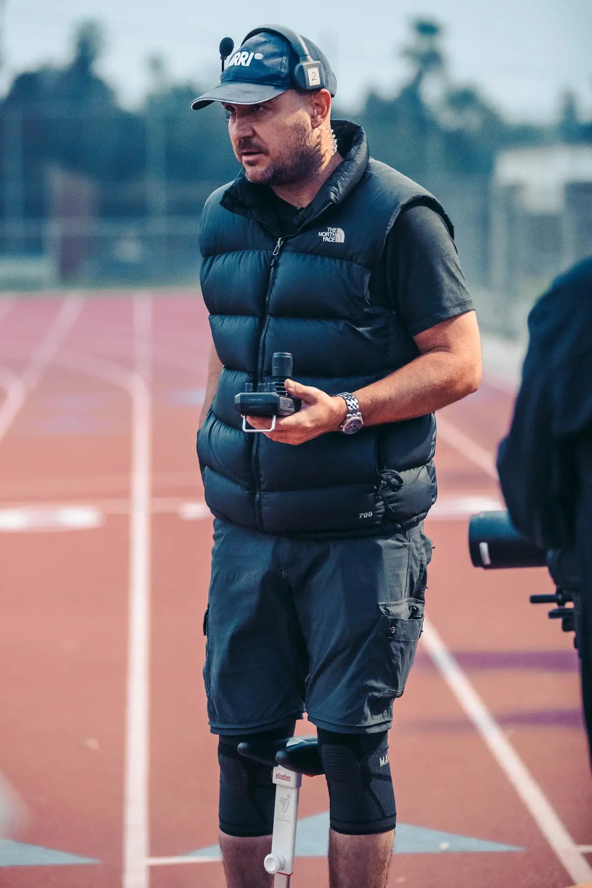 Operator carrying a gimbal rig along the track