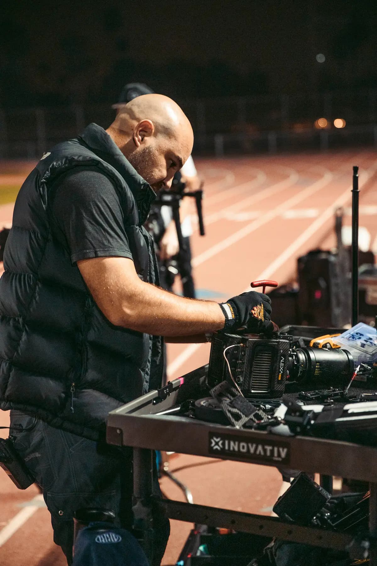 Operator prepping the camera on a dolly cart