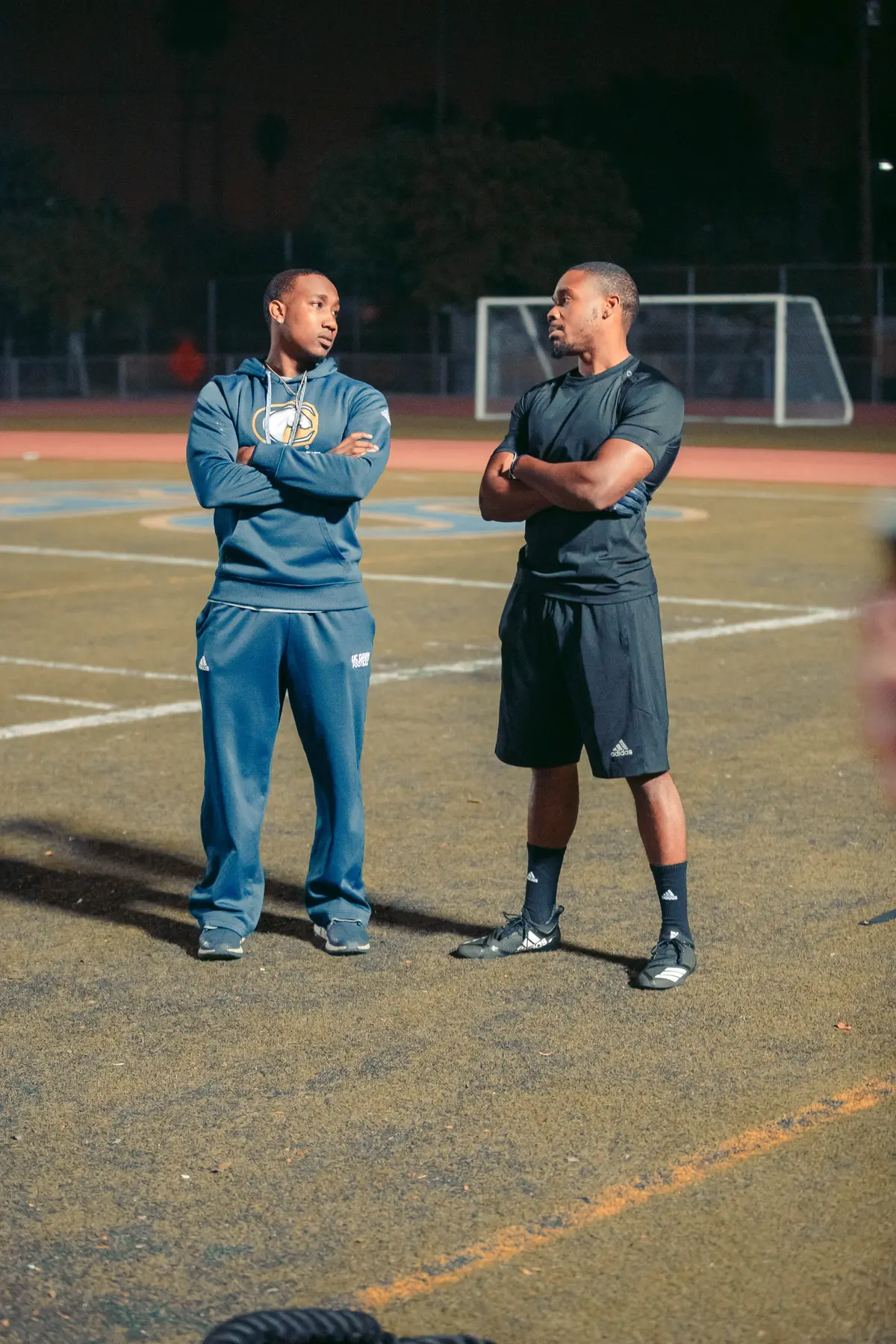 Two athletes talking mid-field during a reset