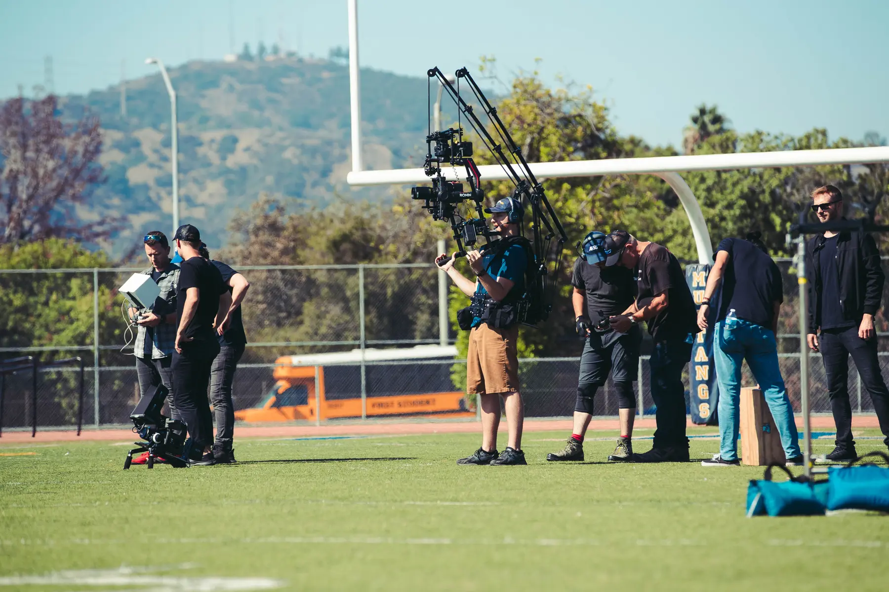 Wide of the unit working the field with hills behind