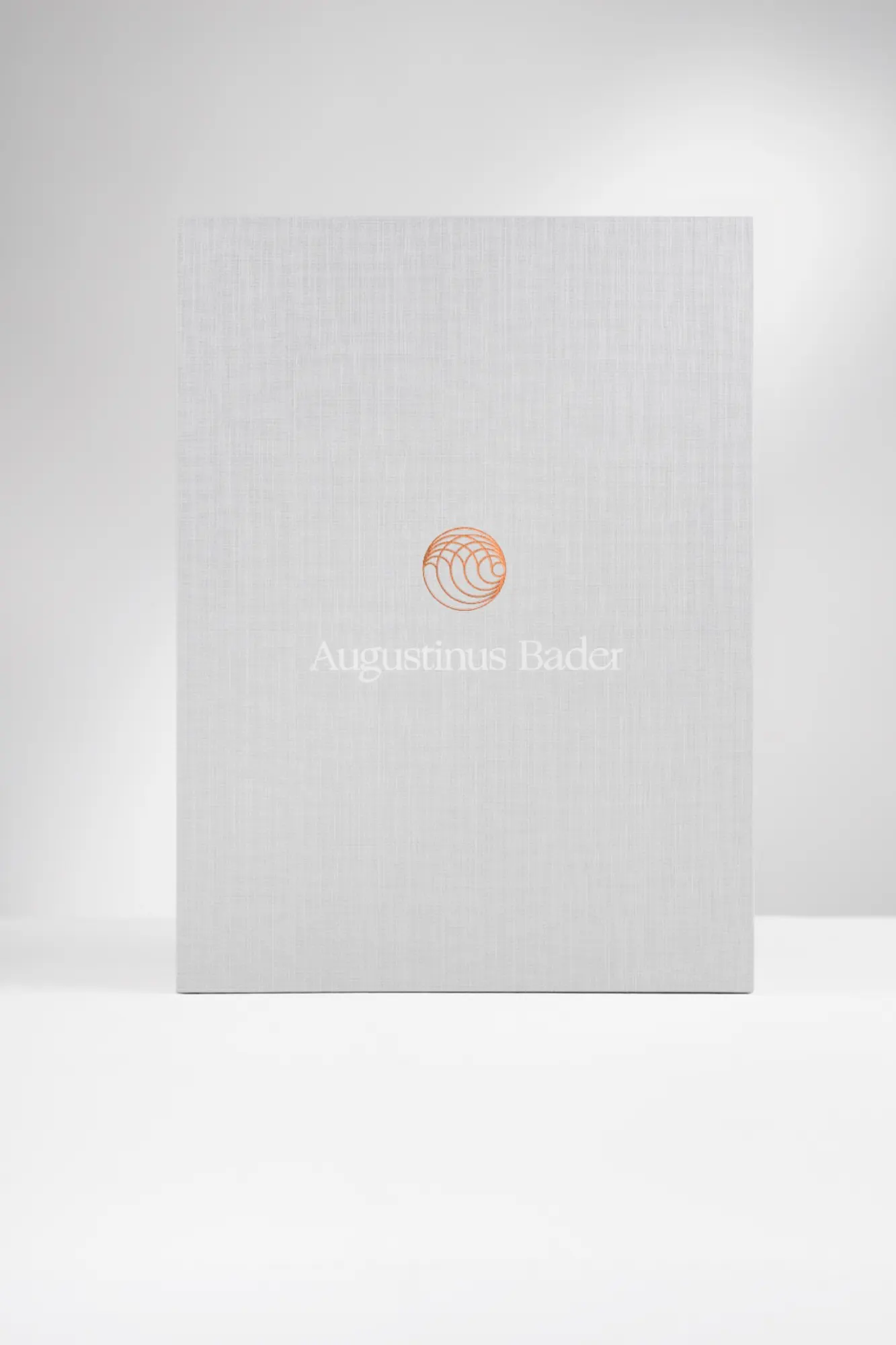 Linen presentation box, copper monogram centred on the cover