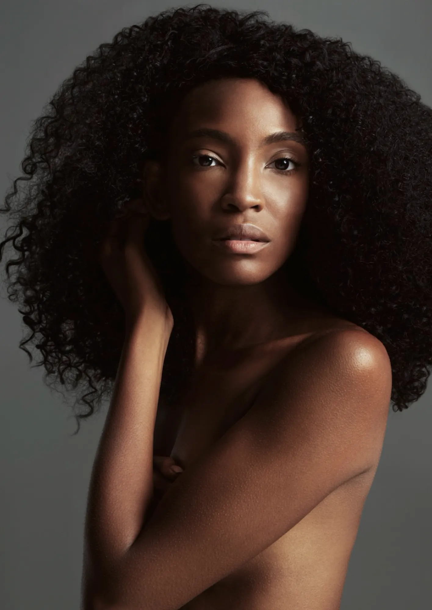 Beauty portrait of a model with a full natural afro, shoulders bare